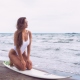 outdoors, sea, beach, waves, one-piece swimsuit, tanned, hips, long hair, brunette, surfing, surfborad wallpaper